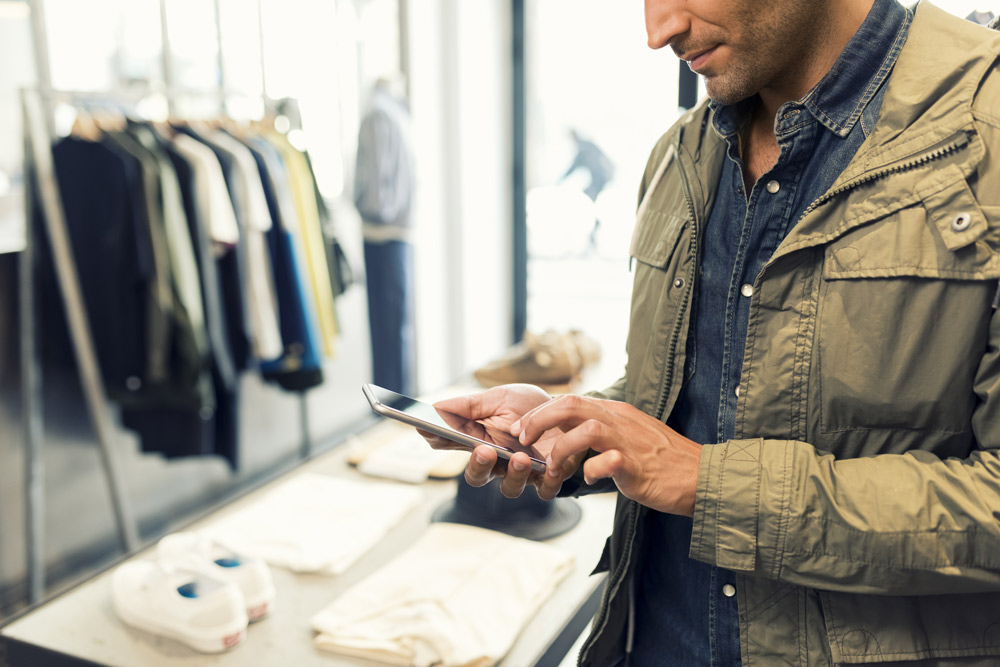 Man with iPhone in a store