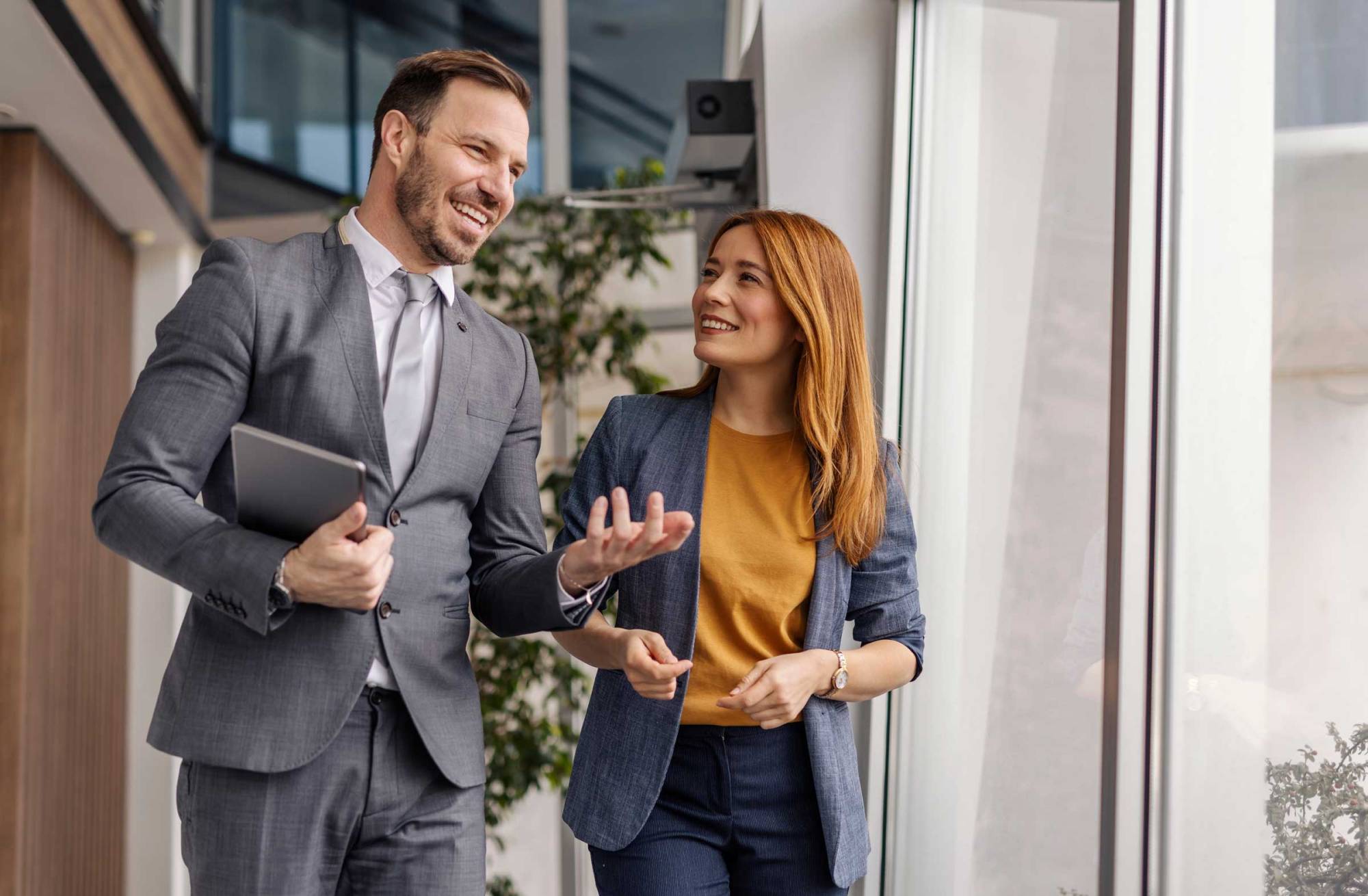 Two proffessionals walking in an office